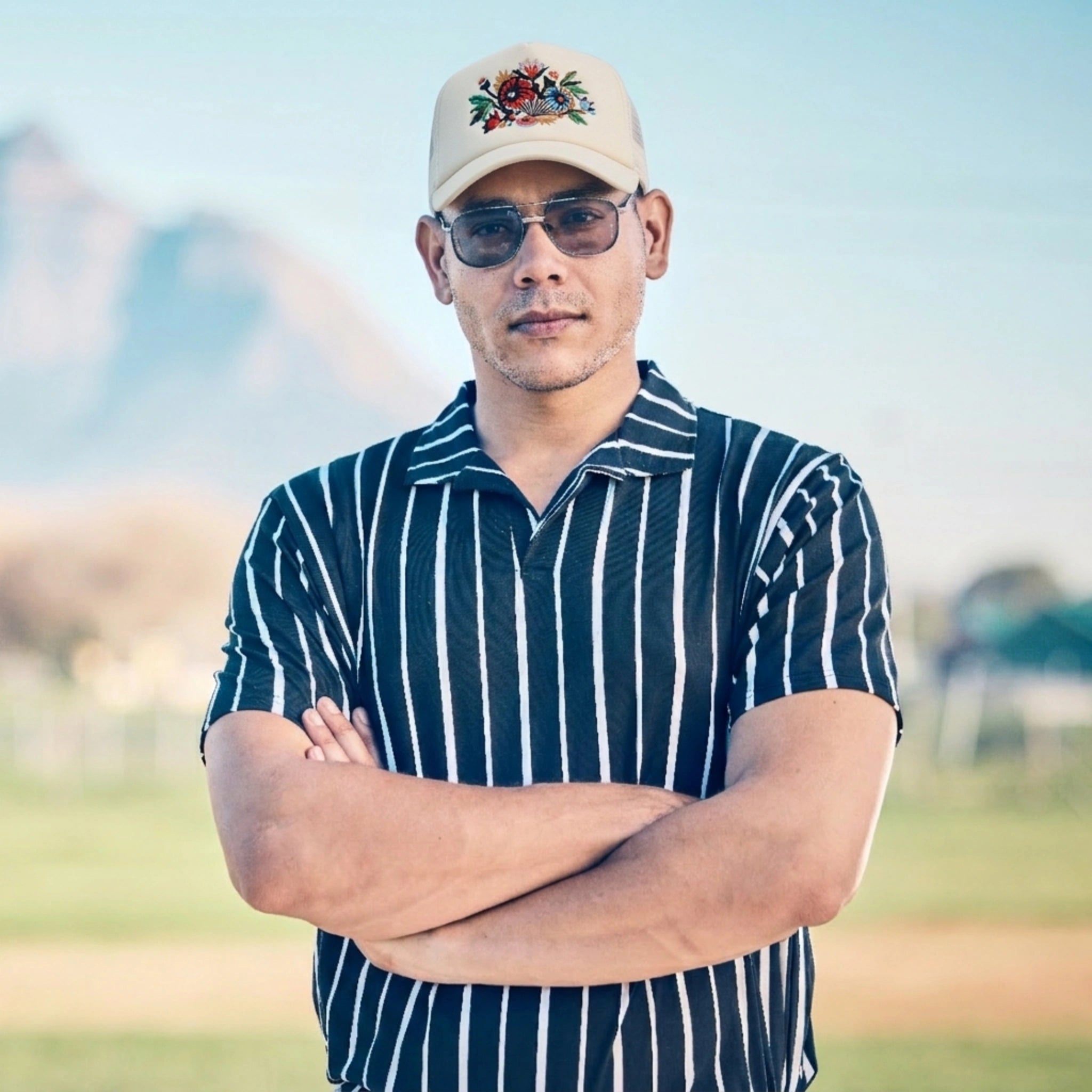 Man Wearing A Striped shirt And Floral Artwork Trucker Cap Jet Stream by AREE Apparel streetwear brand